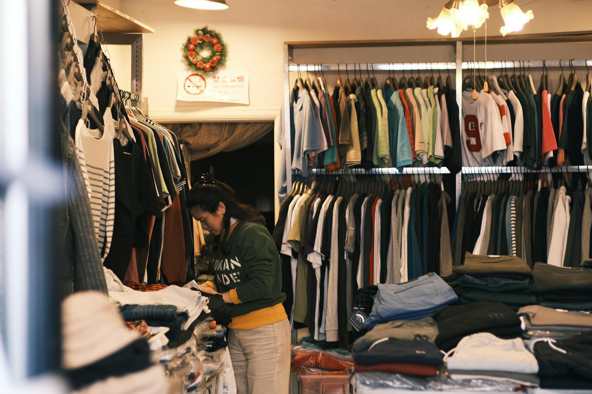 Retail worker organizing clothes in a store