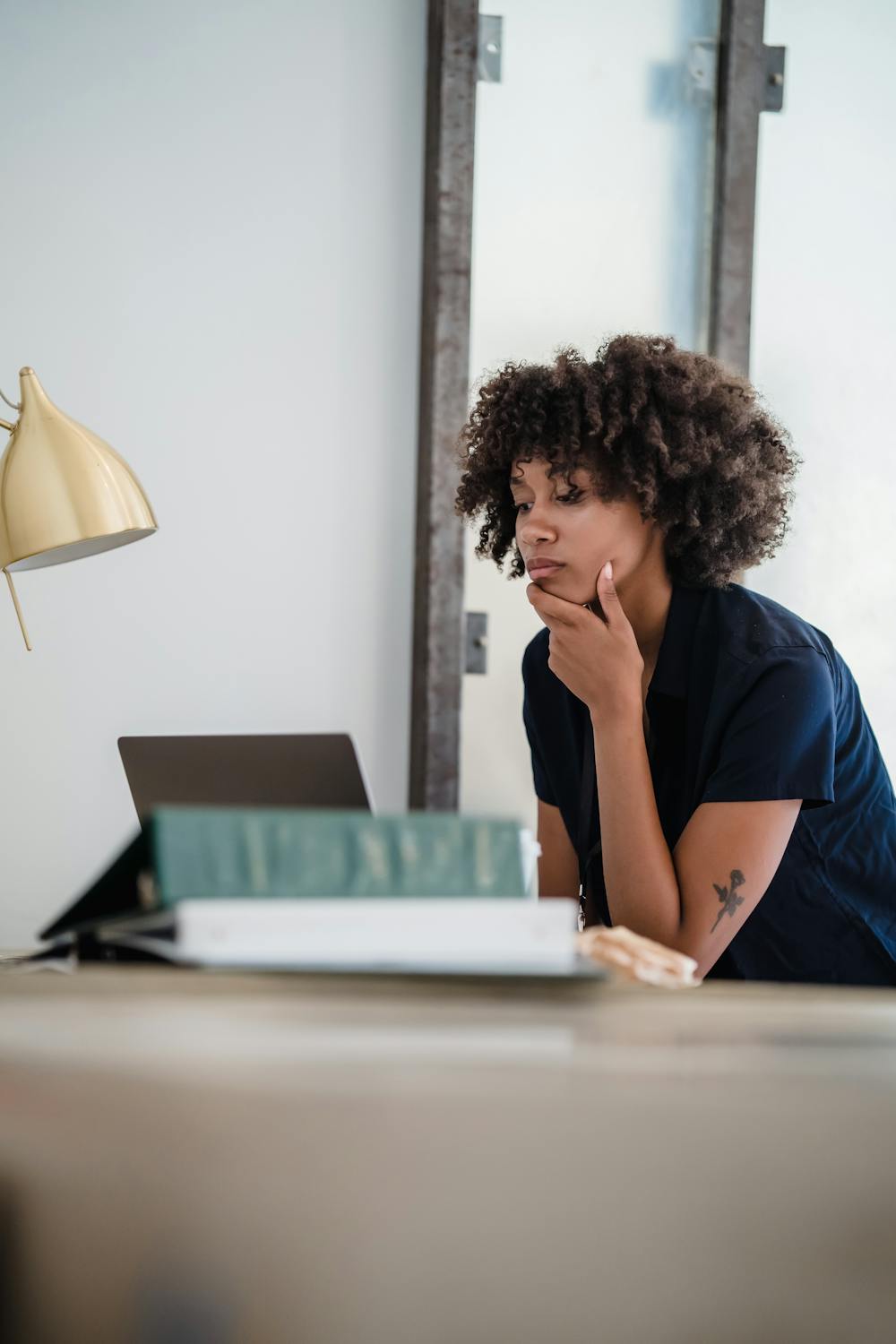 Professional contemplating her workplace rights at her desk
